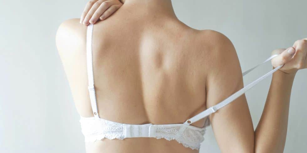 woman holding bra that is not right anymore
