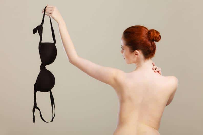 woman holding her bra to the side that is not fitting her anymore